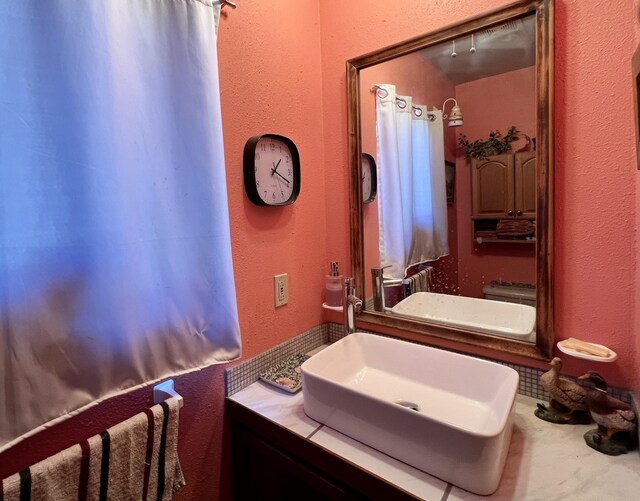 787 Timberlake Rd, Ramah, NM 87321 - bathroom featuring vanity, wood finished floors, and tasteful backsplash