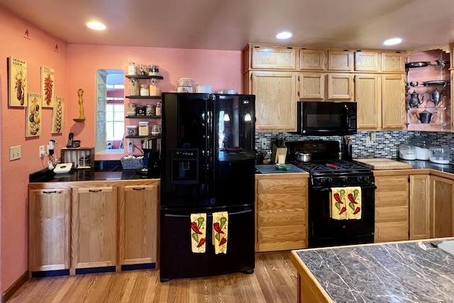 kitchen with decorative backsplash, light brown cabinets, light wood-type flooring, and black appliances