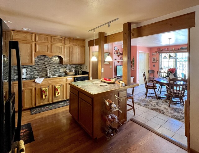 787 Timberlake Rd, Ramah, NM 87321 - kitchen featuring freestanding refrigerator, rail lighting, backsplash, dark wood finished floors, and hanging light fixtures