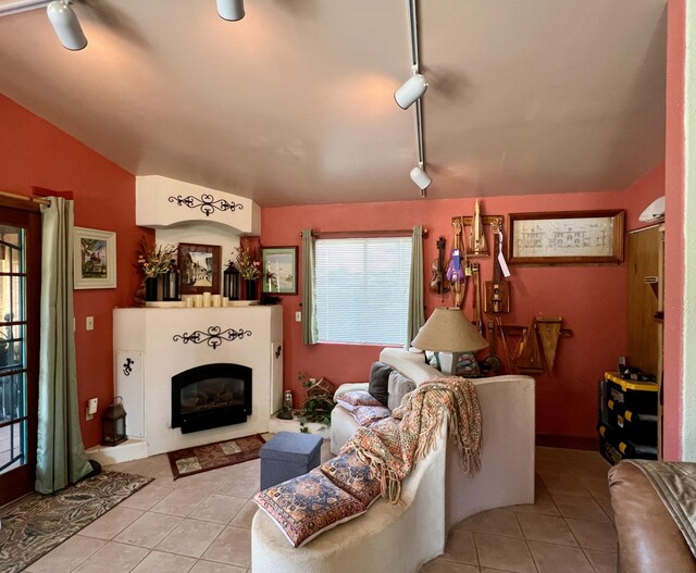 787 Timberlake Rd, Ramah, NM 87321 - living area with tile patterned floors, a glass covered fireplace, rail lighting, and lofted ceiling