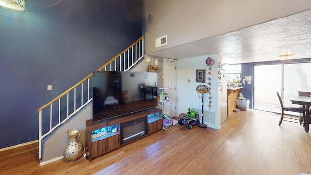 living room with hardwood / wood-style flooring and a textured ceiling