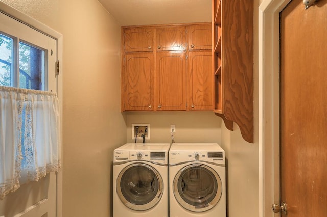 laundry area with cabinets and independent washer and dryer