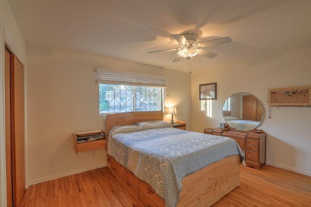 bedroom with ceiling fan, a closet, and light hardwood / wood-style flooring