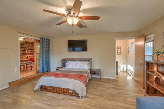 bedroom featuring a baseboard heating unit, a textured ceiling, ceiling fan, and light hardwood / wood-style floors