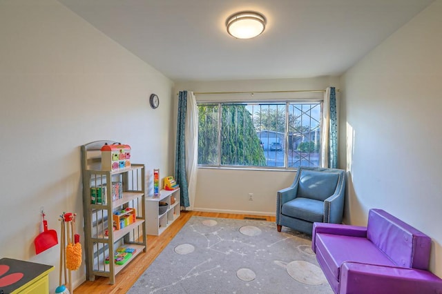 sitting room with hardwood / wood-style floors