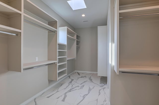 walk in closet featuring a skylight