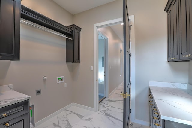 laundry room featuring cabinets, washer hookup, and electric dryer hookup