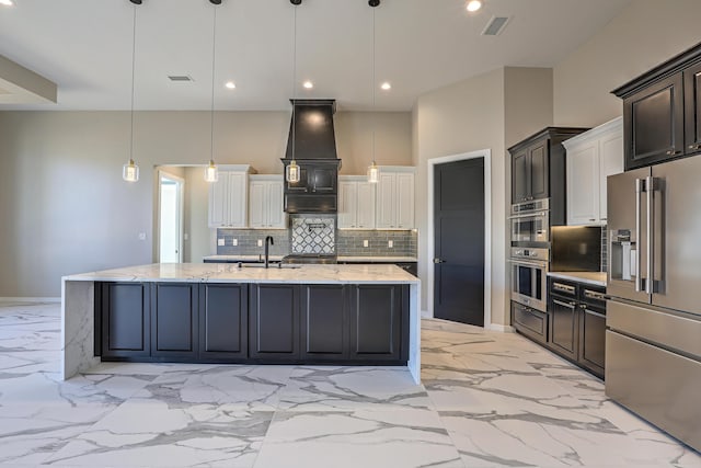 kitchen with a spacious island, sink, pendant lighting, and appliances with stainless steel finishes