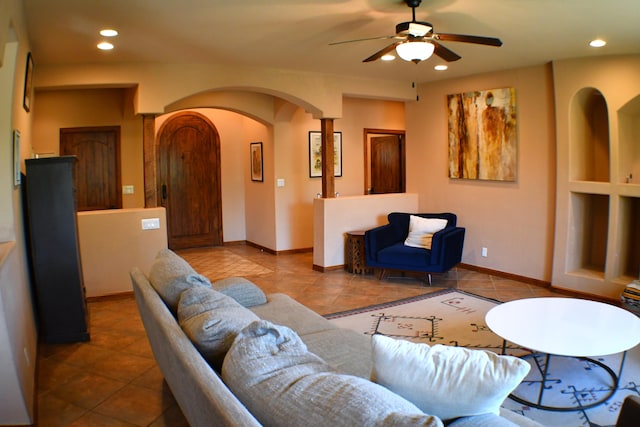 living room featuring ceiling fan and light tile patterned flooring