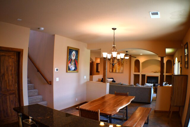 tiled dining room with an inviting chandelier