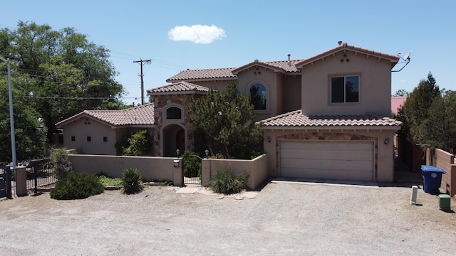 mediterranean / spanish-style house featuring a garage