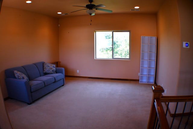 carpeted living room featuring ceiling fan