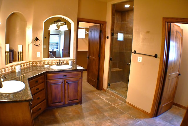 bathroom featuring tile patterned floors, vanity, and an enclosed shower