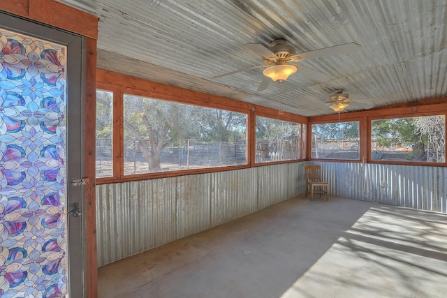 unfurnished sunroom featuring wood ceiling and ceiling fan