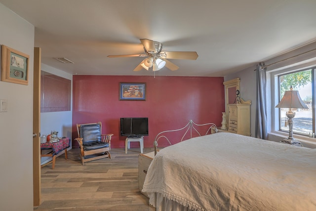 bedroom with hardwood / wood-style floors and ceiling fan