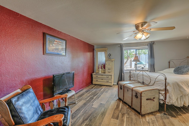 bedroom featuring ceiling fan and wood-type flooring