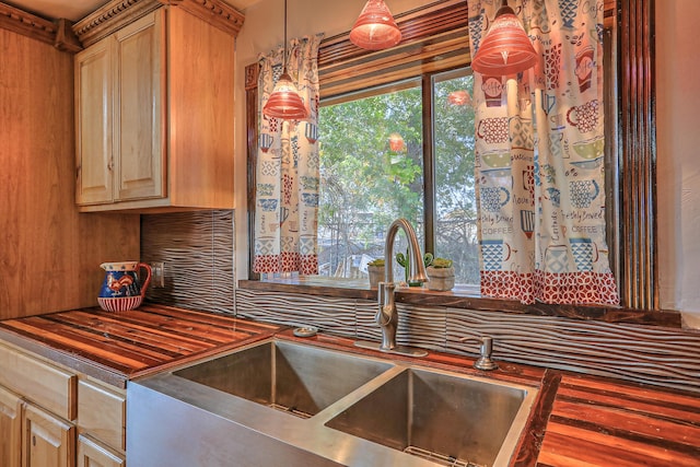 kitchen featuring sink, hanging light fixtures, and light brown cabinetry