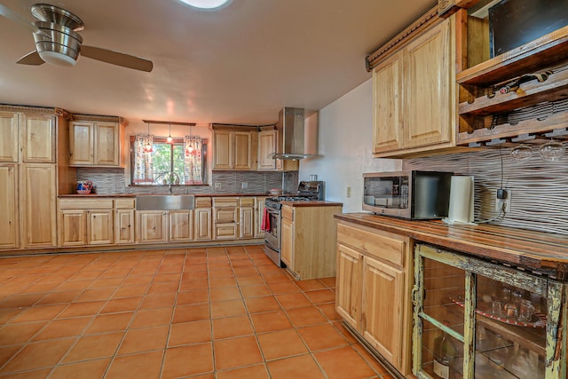 kitchen with wall chimney range hood, stainless steel appliances, wine cooler, sink, and light tile patterned floors