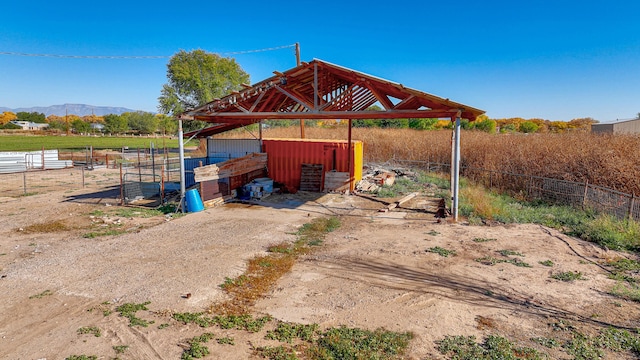 view of outdoor structure featuring a mountain view and a rural view