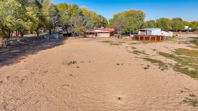 view of yard with an outbuilding and a rural view