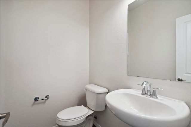 bathroom featuring toilet and sink