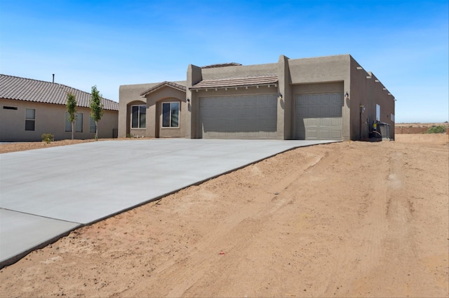 adobe home featuring a garage