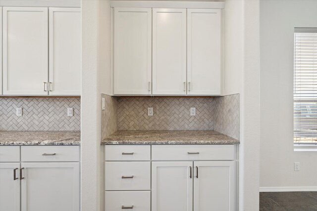 kitchen featuring white cabinets, a wealth of natural light, and tasteful backsplash