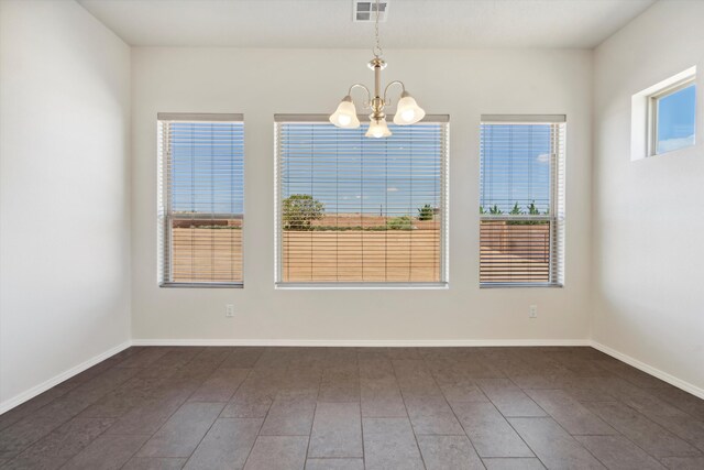 unfurnished dining area with dark hardwood / wood-style floors and a notable chandelier