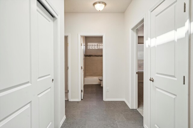 hallway featuring tile patterned flooring