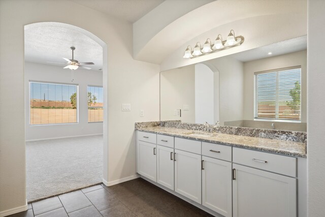 bathroom with tile patterned floors, plenty of natural light, ceiling fan, and vanity