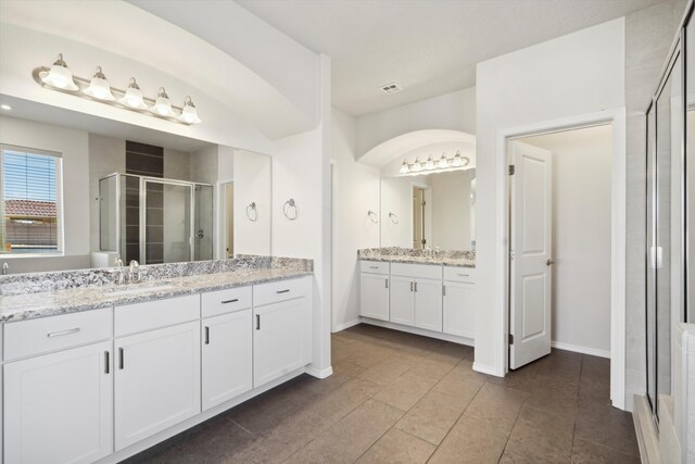 bathroom featuring tile patterned floors, vanity, and an enclosed shower