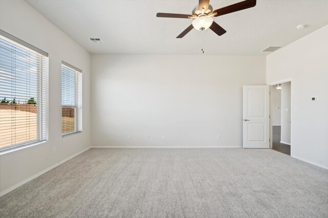 spare room featuring carpet floors and ceiling fan