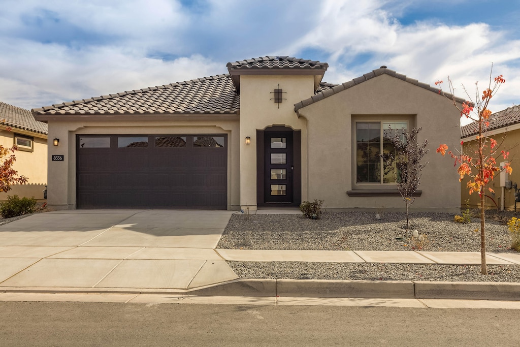 mediterranean / spanish house with a garage