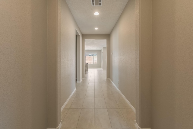 hall with light tile patterned floors