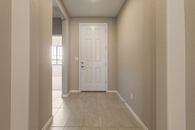 corridor featuring light tile patterned flooring