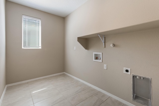 clothes washing area featuring electric dryer hookup, light tile patterned flooring, gas dryer hookup, and hookup for a washing machine