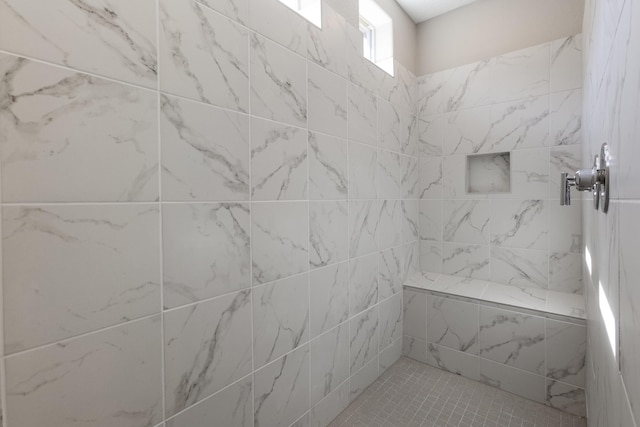 bathroom featuring a tile shower