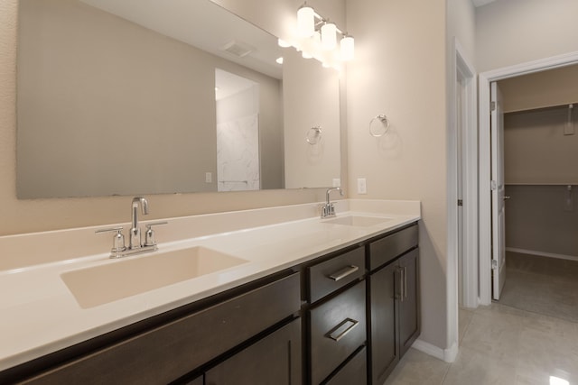 bathroom with tile patterned flooring and vanity