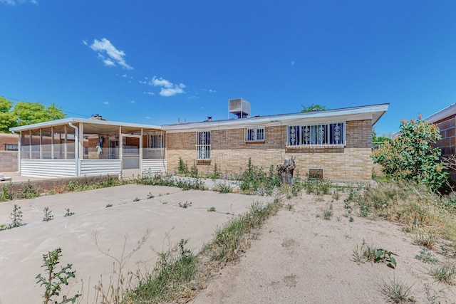 view of front facade featuring a sunroom and brick siding