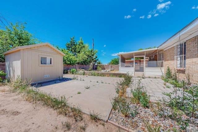 view of yard featuring a shed and a patio area