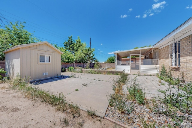 view of yard featuring a sunroom, fence, and a patio