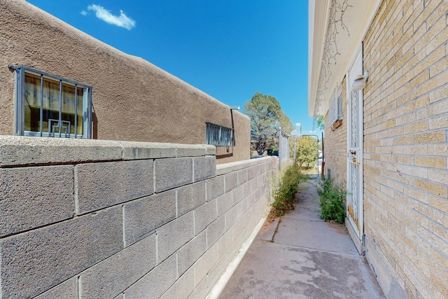 view of side of home featuring fence