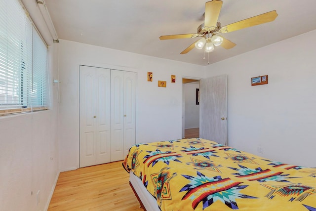 bedroom featuring light hardwood / wood-style floors, a closet, and ceiling fan