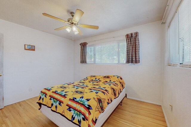 bedroom with ceiling fan and light wood-type flooring