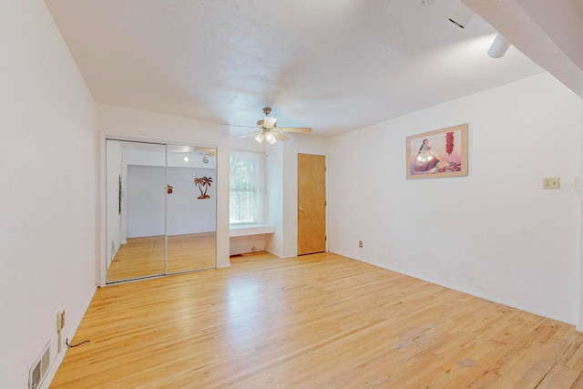 unfurnished bedroom featuring ceiling fan and light hardwood / wood-style floors