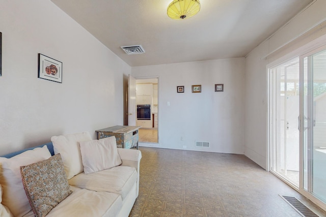 living area with visible vents and tile patterned floors