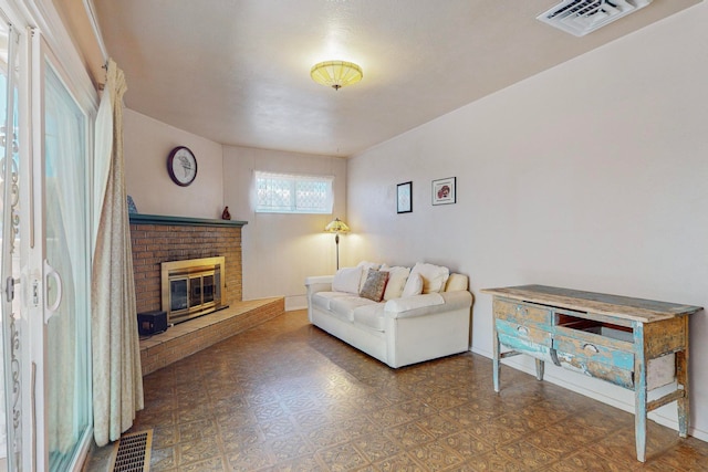 living room with a brick fireplace