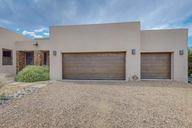 pueblo-style house featuring a garage