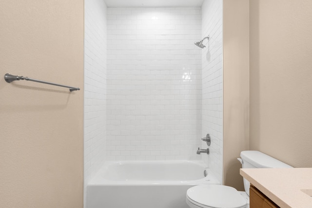 bathroom featuring toilet, vanity, and  shower combination