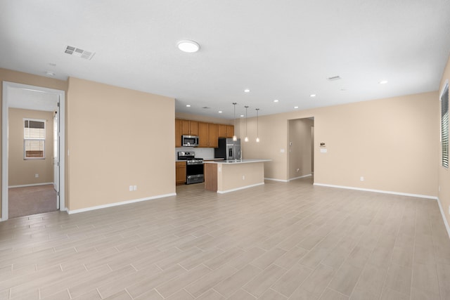 unfurnished living room with recessed lighting, visible vents, baseboards, and light wood finished floors